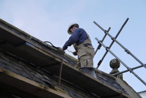 Benny putting mortar under ridge tiles